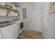 Laundry room with new washer and dryer and ample storage shelving at 404 Troy Pl, Raleigh, NC 27609