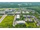 Aerial view showcasing community layout, lush greenery, and convenient access to nearby amenities at 501 Finsbury St # 204, Durham, NC 27703
