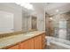 Bathroom featuring granite countertops, modern fixtures, and glass enclosed tiled shower at 501 Finsbury St # 204, Durham, NC 27703
