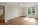 Bright bedroom with hardwood floors, ceiling fan and large window providing ample natural light at 501 Finsbury St # 204, Durham, NC 27703