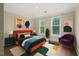 Bright bedroom with two large windows, modern art, and comfortable furnishings at 501 Finsbury St # 204, Durham, NC 27703