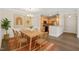 Light filled dining area with wood table, chairs, modern decor, and kitchen views at 501 Finsbury St # 204, Durham, NC 27703