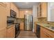 Well-lit kitchen with stainless steel appliances and granite countertops at 501 Finsbury St # 204, Durham, NC 27703