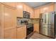 Kitchen featuring stainless steel appliances and light wood cabinetry at 501 Finsbury St # 204, Durham, NC 27703