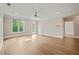Spacious living room with lots of natural light, ceiling fan, and wood floors at 501 Finsbury St # 204, Durham, NC 27703