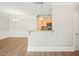 Open-concept living room with hardwood floors adjacent to kitchen with granite countertops and modern appliances at 501 Finsbury St # 204, Durham, NC 27703