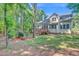 Backyard featuring a deck, mature trees, and a well-maintained lawn at 5107 Granbury Dr, Durham, NC 27713