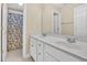 Bathroom featuring double sinks with white cabinets and a shower with cartoon cows at 5107 Granbury Dr, Durham, NC 27713