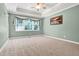Bright bedroom with a tray ceiling, large window, and neutral decor creating a relaxing retreat at 5107 Granbury Dr, Durham, NC 27713
