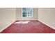 Vacant bedroom featuring red carpet and a window with lots of natural light at 5107 Granbury Dr, Durham, NC 27713