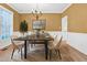 Formal dining room with a modern table set, elegant chandelier, and stylish decor at 5107 Granbury Dr, Durham, NC 27713