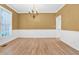 Dining room featuring hardwood floors, chair rail molding, and plenty of natural light at 5107 Granbury Dr, Durham, NC 27713