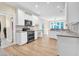 Bright kitchen features white cabinets, stainless steel appliances, and lots of natural light at 5107 Granbury Dr, Durham, NC 27713
