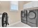 Well-equipped laundry room with modern washer and dryer, plus ample storage space at 5107 Granbury Dr, Durham, NC 27713