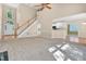 Open-concept living room featuring a staircase, fireplace, and seamless flow into the kitchen, perfect for modern living at 5107 Granbury Dr, Durham, NC 27713