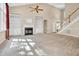 Bright living area featuring built-in shelving, a fireplace, and neutral carpeting at 5107 Granbury Dr, Durham, NC 27713