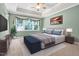 Spacious main bedroom with a tray ceiling, large window, and neutral decor creating a relaxing retreat at 5107 Granbury Dr, Durham, NC 27713
