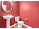 Stylish half bathroom features a pedestal sink and decorative mirror in a modern design at 5107 Granbury Dr, Durham, NC 27713
