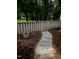 This backyard features a stone path with a garden and a fence that provides privacy at 5805 Mapleridge Rd, Raleigh, NC 27609