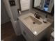 Close-up on bathroom sink vanity with modern fixtures and neutral color scheme at 5805 Mapleridge Rd, Raleigh, NC 27609