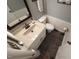 Cozy bathroom with stylish vanity, modern fixtures, and contemporary tile flooring at 5805 Mapleridge Rd, Raleigh, NC 27609