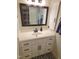 Clean white bathroom vanity with dark bronze fixtures and a large mirror at 5805 Mapleridge Rd, Raleigh, NC 27609