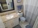This bathroom features a single sink, tan countertops, and blue towels that add a pop of color at 5805 Mapleridge Rd, Raleigh, NC 27609