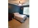 Relaxing bedroom with blue walls, large window with natural light and wooden furniture set at 5805 Mapleridge Rd, Raleigh, NC 27609