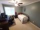 A tidy bedroom features a ceiling fan, a window, and workspace with computer setup at 5805 Mapleridge Rd, Raleigh, NC 27609