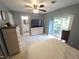 This bedroom features blue walls, a ceiling fan, and a sliding glass door to a small balcony at 5805 Mapleridge Rd, Raleigh, NC 27609