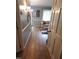 Hallway view of a comfortable living room with neutral colors and bright window lighting at 5805 Mapleridge Rd, Raleigh, NC 27609