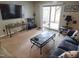 This living room features a dark sofa, a unique coffee table, and sliding doors to the outside at 5805 Mapleridge Rd, Raleigh, NC 27609