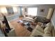 Comfortable living room with hardwood floors, neutral colors, and bright window lighting at 5805 Mapleridge Rd, Raleigh, NC 27609