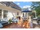 Backyard featuring deck with patio furniture and grill surrounded by green trees at 5908 Danville Dr, Raleigh, NC 27612