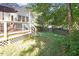 Backyard showing deck, stairs, fenced in lawn with mature landscaping at 5908 Danville Dr, Raleigh, NC 27612