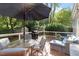 Backyard featuring deck with patio furniture and a grill surrounded by green trees at 5908 Danville Dr, Raleigh, NC 27612
