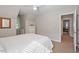 Bright bedroom features a sloped ceiling, natural light, and modern white dresser at 5908 Danville Dr, Raleigh, NC 27612