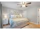 Comfortable bedroom with ceiling fan, hardwood floors and neutral paint color; has access to the hallway at 5908 Danville Dr, Raleigh, NC 27612