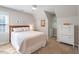 Attic bedroom with sloped ceiling features a cozy bed, dresser, and large window at 5908 Danville Dr, Raleigh, NC 27612