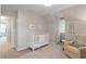 Cozy Bedroom with white crib, comfortable chair, and soft rug at 5908 Danville Dr, Raleigh, NC 27612