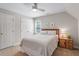 Attic bedroom with sloped ceilings, a double closet, and a side table with natural light at 5908 Danville Dr, Raleigh, NC 27612