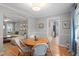 Cozy dining area with hardwood floors, a round wood table, and easy access to the kitchen and living room at 5908 Danville Dr, Raleigh, NC 27612