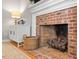 Close-up of brick fireplace with mantel, decorative accents, and a rustic basket at 5908 Danville Dr, Raleigh, NC 27612