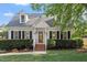 Charming two-story home featuring a brick walkway, manicured landscaping, and a classic architectural design at 5908 Danville Dr, Raleigh, NC 27612