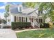 Charming two-story home featuring a brick walkway, manicured landscaping, and a classic architectural design at 5908 Danville Dr, Raleigh, NC 27612