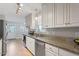 Well-lit kitchen with white cabinets, stainless steel appliances, granite counters, and backyard access at 5908 Danville Dr, Raleigh, NC 27612