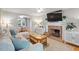 Cozy living room with brick fireplace, plush sofa, neutral walls, and a connecting dining area at 5908 Danville Dr, Raleigh, NC 27612
