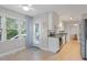 Bright sunroom with tile floors, a ceiling fan, and natural light; has access to the kitchen and backyard at 5908 Danville Dr, Raleigh, NC 27612