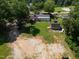 Aerial view of the property highlighting the home's location, backyard space, outbuilding, and surrounding landscape at 6005 Lake Wheeler Rd, Raleigh, NC 27603