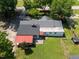 Aerial view of the home showcasing its roof, spacious backyard, patio area, and surrounding mature trees at 6005 Lake Wheeler Rd, Raleigh, NC 27603